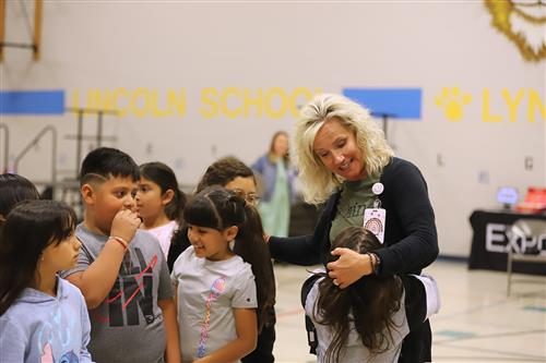 Mrs. Schultz is hugged by students after winning her award.